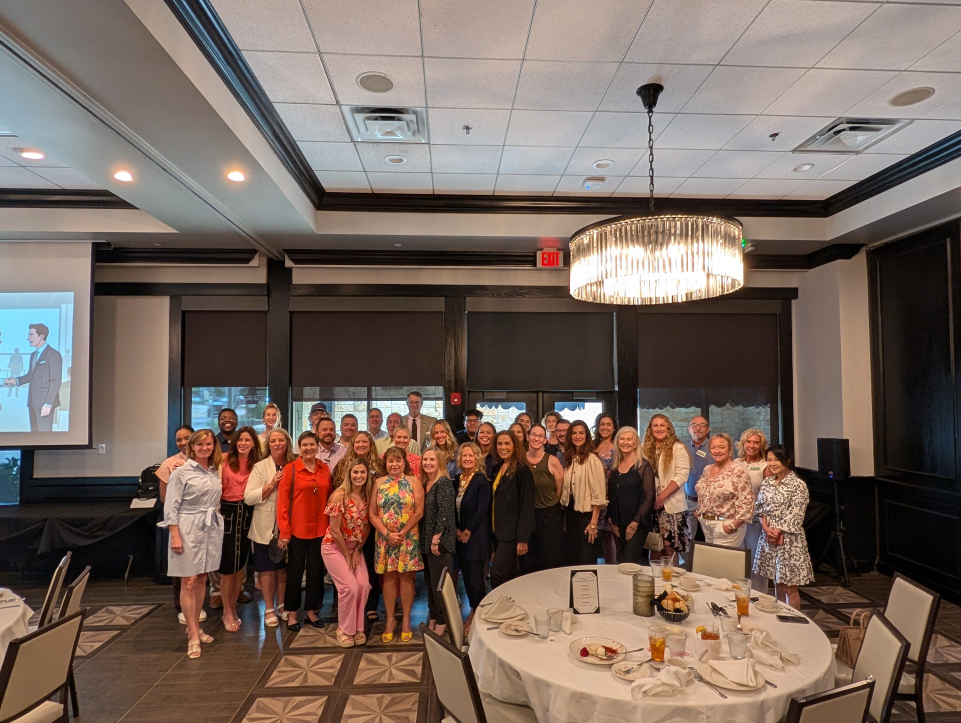 Suha Beidas Zehl, CMB®, AMSP™ with guests at a formal industry luncheon